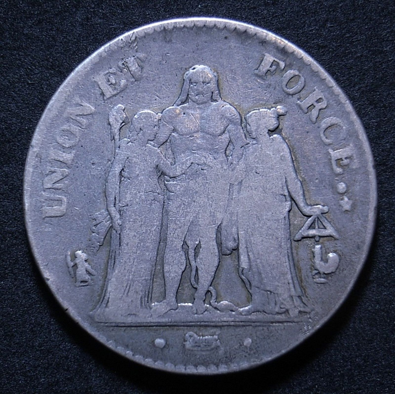 Close up French 5 Francs L'An 7 obverse showing detail on the coin