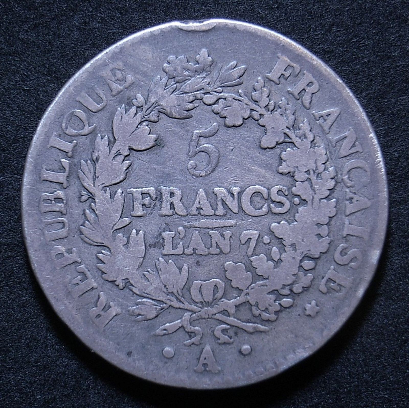 Close up French 5 Francs L'An 7 reverse showing detail on the coin