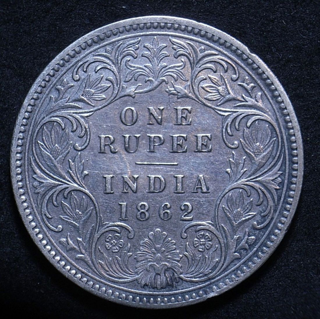 Close up of Indian 1862 rupee reverse showing the coin's detail