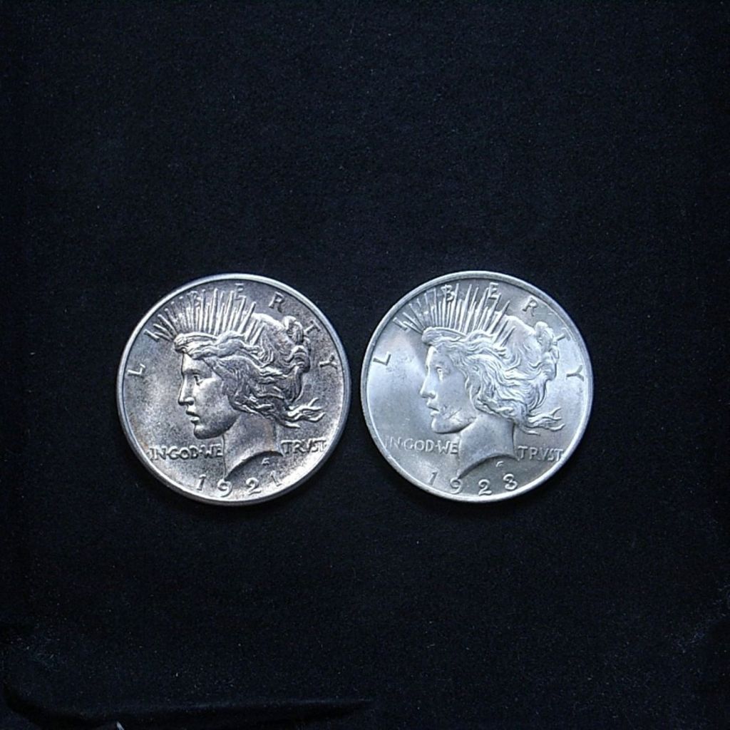 Comparison of relief on US 1921 vs 1923 Peace dollar obverse, highlighting lustre on the coins